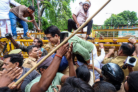 Police personnel stop Congress workers as they scale the barricades during a protest march condemning the detention of LoP in Lok Sabha Rahul Gandhi and other party leaders in a sit-in protest near PM's residence in Delhi on Tuesday, in Lucknow, Uttar Pradesh.
