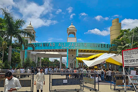 People gather outside the Mohammad Ali Jauhar University during a sit-in protest over the order for demolition of 38 buildings of the university, in Rampur, Uttar Pradesh.)
