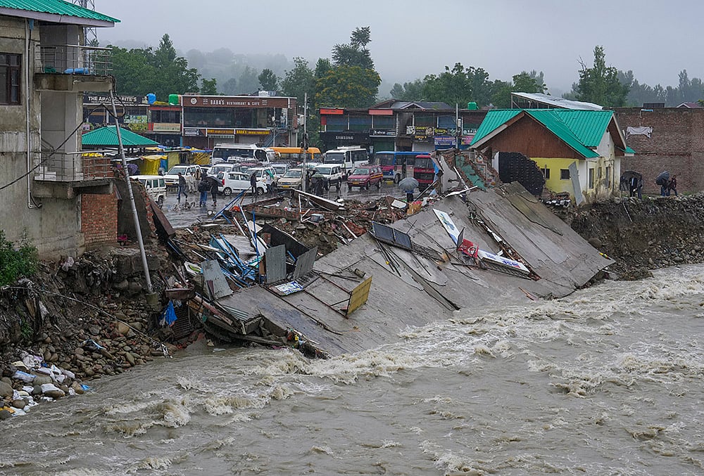 A damaged embankment along a swollen stream following floods and rainfall, in Khag area, Budgam district, Jammu and Kashmir, Wednesday, July 22, 2026.  - | Photo: PTI/S Irfan