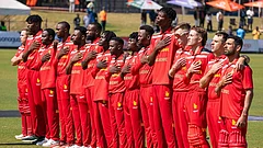 Zimbabwe's players line up in their retro 1992 World Cup-inspired red jerseys for the national anthem before the first T20I against India at Harare Sports Club, paying tribute to a landmark era in the nation's cricket history. - X/ZimCricketv