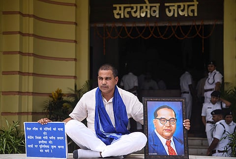 Bahujan Samaj Party (BSP) MLA Satish Das stages a protest over the alleged NEET paper leak issue during the Monsoon session of the Bihar Legislative Assembly, in Patna.