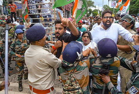 Security personnel intervene as Congress and BJP workers clash during a Congress protest outside the BJP state headquarters over the alleged NEET paper leak issue, in Ranchi, Thursday, July 23, 2026. 
