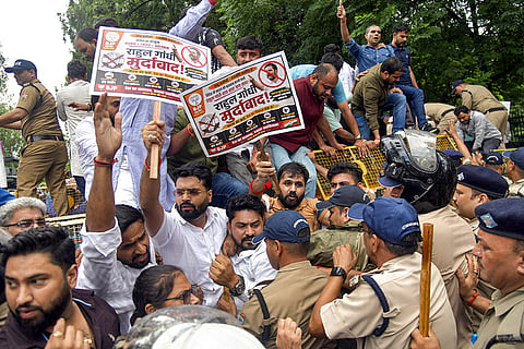 Police personnel stop BJP workers after they take out a protest march towards the Uttarakhand Congress headquarters over the sit-in protest by LoP in Lok Sabha Rahul Gandhi and other Congress leaders near PM's residence in Delhi on Tuesday, in Dehradun.