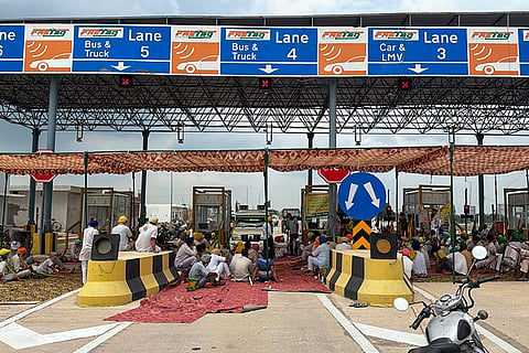 Samyukt Kisan Morcha members block a toll plaza during a protest against the proposed India–US trade deal, in Patiala.