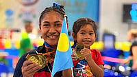 Insta/ Vodafone Samoa : Samoa wrestler Seine Stowers posing with her daughter, flexing her medals