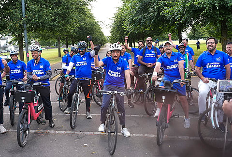 Union Youth Affairs and Sports Minister Mansukh Mandaviya leads participants during a cycle rally from the Collins fountain at Glasgow Green ahead of the 2026 Commonwealth Games, in Glasgow, Scotland.