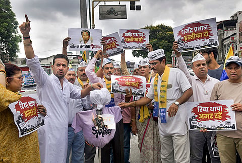 AAP workers burn an effigy as they stage a protest in solidarity with climate activist Sonam Wangchuk and demand the resignation of Union Education Minister Dharmendra Pradhan over the NEET paper leak issue, in Dehradun, Uttarakhand, Thursday, July 23, 2026. 