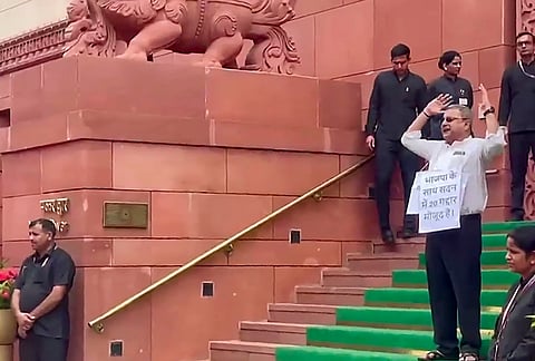 Suspended Trinamool Congress (TMC) MP Kalyan Banerjee stages a protest outside Parliament during the Monsoon Session, in New Delhi.