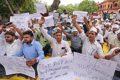 Aspirants stage a protest demanding the issuance of advertisements for approximately 23,775 vacant TGT and PGT posts based on the old recruitment rules, in Prayagraj, Uttar Pradesh.
