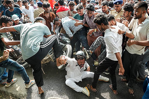 People clash near the Chief Minister's residence during the 'Lok Bhavan March' organised by AISA over the alleged NEET paper leak issue, in Patna.