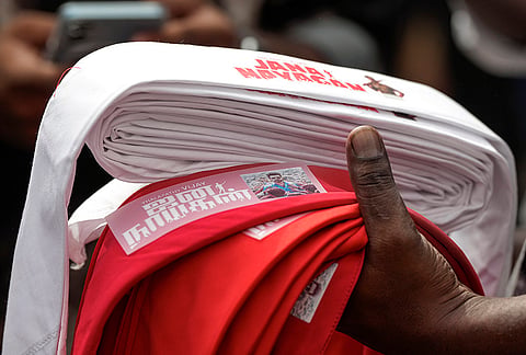 A fan carries headbands bearing the title of actor and Tamil Nadu Chief Minister Joseph Vijay during the theatrical release of his film ‘Jana Nayagan', in Chennai, Thursday, July 23, 2026. 