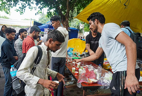 Cockroach Janata Party (CJP) supporters received free food being distributed during a protest at the Jantar Mantar, in New Delhi. The agitation, which began on June 20, is demanding accountability over alleged irregularities in competitive examinations, reforms in the education system and the resignation of Union Education Minister Dharmendra Pradhan, and compensation for families of students who allegedly committed suicide due to the paper leak. 