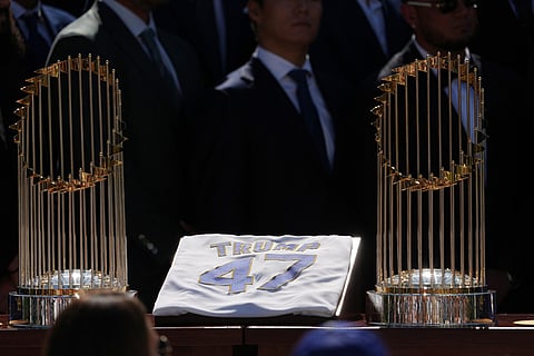 Two trophies and a jersey are displayed as President Donald Trump speaks during an event to honor the 2025 World Series champions Los Angeles Dodgers in the Rose Garden of the White House in Washington.
