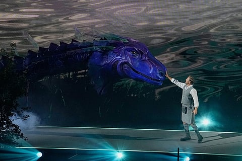 A performer reaches out to touch the mythical Loch Ness monster known as 'Nessie' during the Commonwealth Games opening ceremony in Glasgow, Scotland.