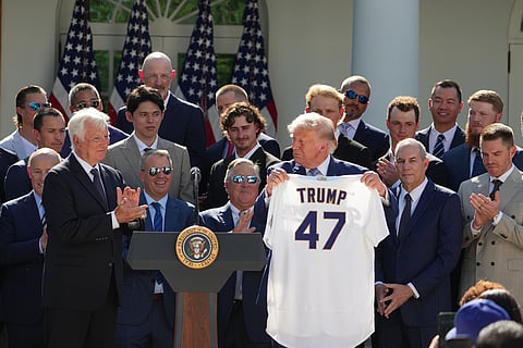 President Donald Trump holds up a jersey during an event to honor the 2025 World Series champions Los Angeles Dodgers in the Rose Garden of the White House in Washington.