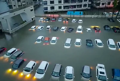 | Photo: PTI : Vehicles partially submerged after incessant rains, in Vapi, Gujarat, Thursday, July 23, 2026.