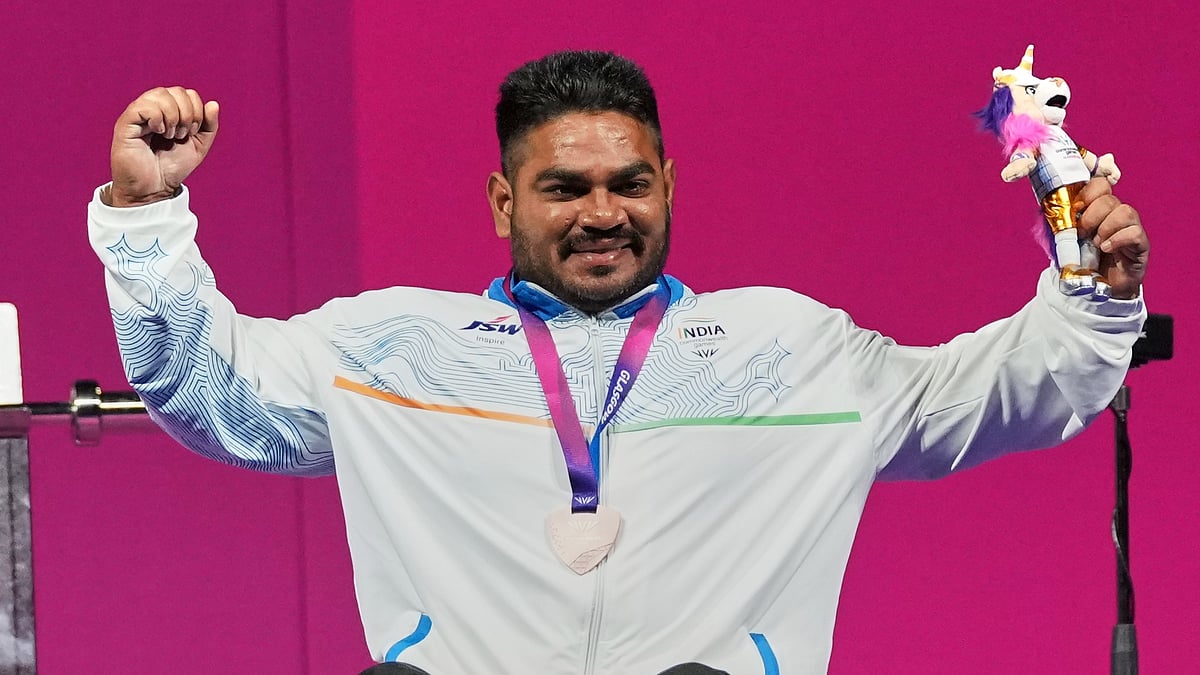 (AP Photo/Eranga Jayawardena) : Indias Jhandu Kumar celebrates his bronze medal won in the mens heavy weight para power lifting during the Commonwealth Games in Glasgow, Scotland, Friday, July 24, 2026