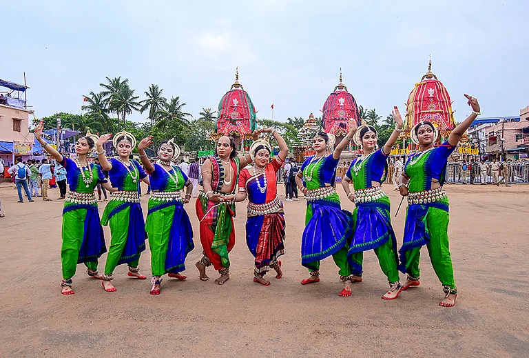 Odissi dancers pose for photographs in front of the chariots of Lord Jagannath, Lord Balabhadra and Goddess Subhadra before the 'Bahuda Yatra', or the return car festival, in Puri, Odisha. - | Photo: PTI