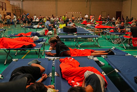 Residents spend the night at a sports center after being evacuated from their homes because of the threat of a wildfire in Cebreros, Ávila province, Spain.