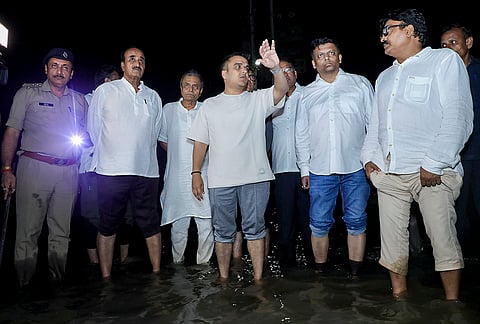 Gujarat Deputy Chief Minister Harsh Sanghavi with others during a visit to a flood-affected area following heavy monsoon rains, in Navsari district. 