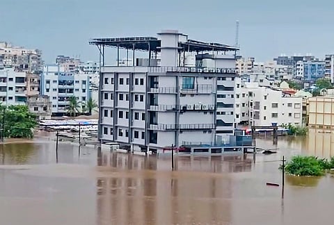 Floodwater inundates an area following heavy rainfall, in Navsari district, Gujarat, Friday, July 24, 2026. 