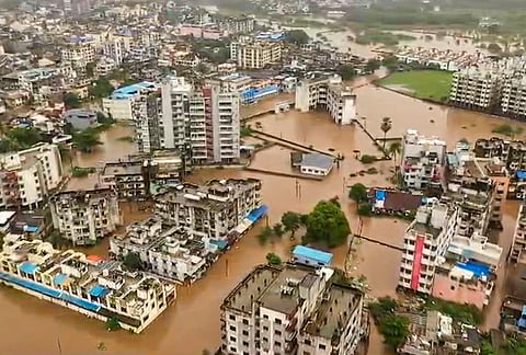 Residential buildings partially submerged after incessant rains, in Navsari, Gujarat, Thursday, July 23, 2026. 