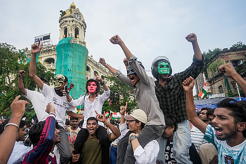 People take part in a joint protest rally by Students Federation of India (SFI) along with Cockroach Janata Party demanding the resignation of Union Education Minister Dharmendra Pradhan over the NEET paper leak issue, in Kolkata, West Bengal.