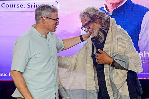 Jammu and Kashmir Chief Minister Omar Abdullah greets Bollywood filmmaker and Padma Shri awardee Muzaffar Ali during the curtain-raiser of the first International Film Festival of Jammu and Kashmir, in Srinagar.