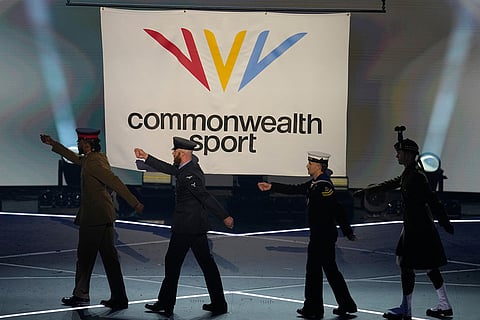 The flag of Commonwealth Sport is raised as the military flag carriers march off during the Commonwealth Games opening ceremony in Glasgow, Scotland.