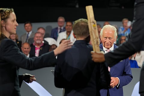 Britain's King Charles III, watches as the Scottish Baton that has travelled over 20,000 miles arrives at the Commonwealth Games opening ceremony in Glasgow, Scotland.