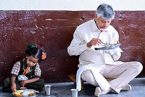 In this image received on July 24, 2026, Andhra Pradesh Chief Minister N Chandrababu Naidu eats lunch with a student during the mega parent-teacher meeting programme, at Government High School in Alluri Sitharama Raju district.