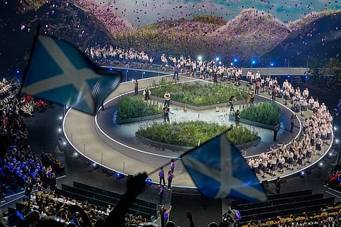 Scottish flags are waved by fans as the Scotland team arrives on stage during the Commonwealth Games opening ceremony in Glasgow, Scotland.