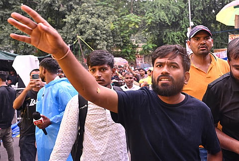 Abhijeet Dipke, founder of the Cockroach Janta Party, interacts with the protesters during a demonstration demanding educational reforms as part of the party's ongoing protest movement in New Delhi.