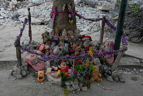 Stuffed animals and toys found at the OPP 25 residential building, which collapsed during the earthquake, are piled into a makeshift memorial in La Guaira, Venezuela, Friday, July 17, 2026. 