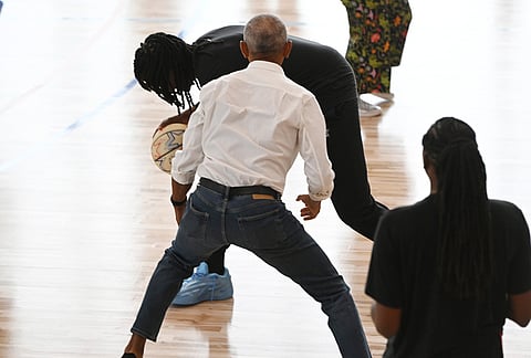 Former President Barack Obama briefly guards WNBA All-Star Jonquil Jones during a practice at the Obama Presidential Center in Chicago, Friday, July 24, 2026. 