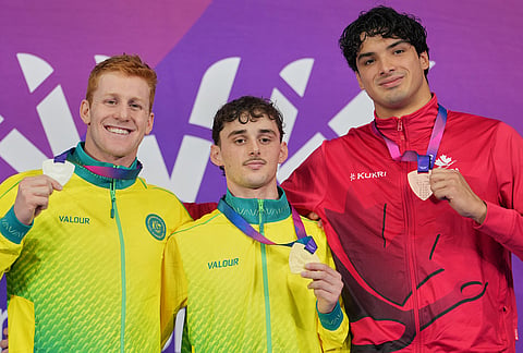 Alex Saffy of Australia with his gold, centre, Col Pearse of Australia, left, silver, and Jack Gill of Canada, bronze medal, pose on the podium for the men's 100 meter butterfly S10 swimming event medal ceremony during the Commonwealth Games in Glasgow, Scotland, Friday, July 24, 2026. 