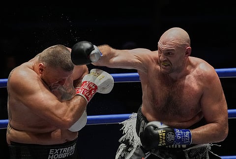 Tyson Fury, of England, right, and Mariusz Wach of Poland, battle during a heavyweight charity bout at Max Muay Thai Stadium in Pattaya, Thailand, Friday, July 24, 2026. 