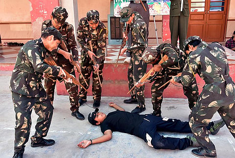 School students dressed in military uniforms stage a mock anti-terror operation on the eve of 'Kargil Vijay Diwas' in honor of Kargil war martyrs, in Bikaner, Rajasthan.