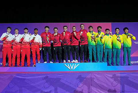 Gold medalist Canada, center, Silver medalist England and Bronze medalist Australia, winners of the men's artistic gymnastics team final, pose for the photographs at the Commonwealth Games in Glasgow, Scotland, Friday, July 24, 2026.