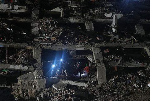 Relatives and rescue workers search through a collapsed building by the earthquakes for their love ones in La Guaira, Venezuela, Tuesday, July 21, 2026. 
