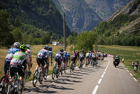 The pack rides during the nineteenth stage of the Tour de France cycling race with start in Gap and finish in Alpe d'Huez, France, Friday, July 24, 2026. 