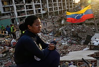 Grief And Hope: Families Continue Search For Loved Ones A Month After Venezuela Earthquakes | Photo: AP/Ariana Cubillos : Estefany Landaez sits amid the rubble of a building, waiting to find her two children after the earthquakes in La Guaira, Venezuela, Sunday, July 12, 2026.