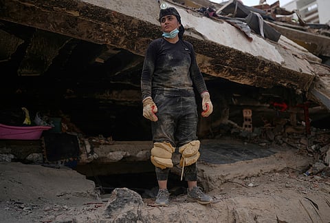 Maria Morales stands on a collapsed building by the earthquakes, searchig for her aunt Yaeina Vera in La Guaira, Venezuela, Thursday, July 23, 2026. 