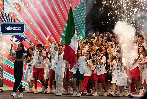 Gabriela Rodriguez and Juan Manuel Celaya of Mexico carry their country's flag during the opening ceremony of the Central American and Caribbean Games in Santo Domingo, Dominican Republic, Friday, July 24, 2026. 
