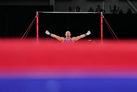 Scotland's Hamish Carter celebrates as he competes at the Horizontal bar during men's team final and individual qualification of Artistic Gymnastics at the Commonwealth Games in Glasgow, Scotland, Friday, July 24, 2026. 