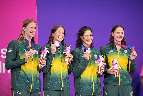 The South African women's 4x100 meter freestyle relay swimming team of Aimee Canny, Rebecca Meder, Erin Gallagher and Olivia New pose for the media on the podium with their bronze medals during the Commonwealth Games in Glasgow, Scotland, Friday, July 24, 2026. 