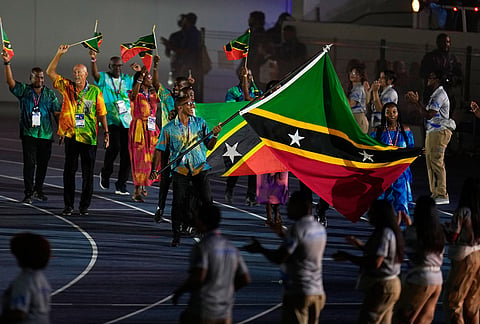 Emmbriel Flanders and Adaya Bourne of Saint Kitts y Nevis carry their country's flag during the opening ceremony of the Central American and Caribbean Games in Santo Domingo, Dominican Republic, Friday, July 24, 2026. 
