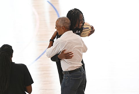 Former President Barack Obama hugs WNBA All-Star Jonquil Jones after briefly guarding her during a practice at the Obama Presidential Center in Chicago, Friday, July 24, 2026.