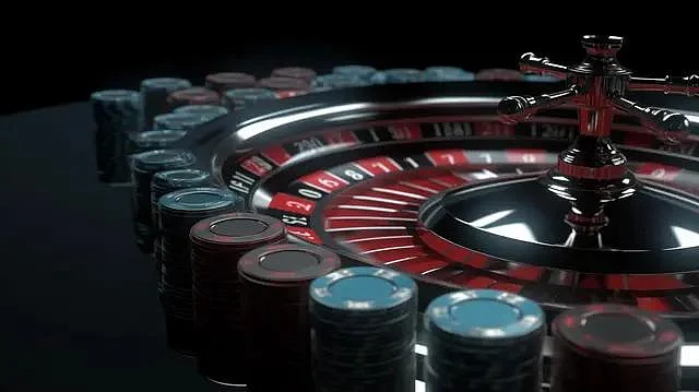 A closeup of a shiny casino roulette wheel and chips