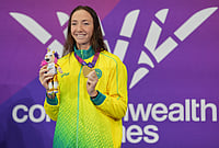 | Photo: AP/Kin Cheung : Lani Pallister of Australia holds up her gold medal for winning the final of the women's 400 meter freestyle swimming event during the Commonwealth Games in Glasgow, Scotland, Friday, July 24, 2026. 